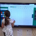 dziewczynka rozwiązuje kodowankę na tablicy multimedialnej.jpg